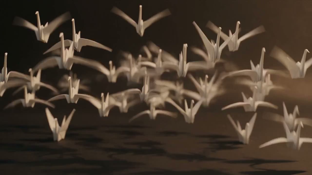 A flock of origami cranes taking flight through warm light